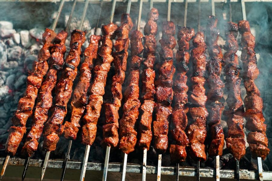 Beef skewers grilling on charcoal for boat barbecue