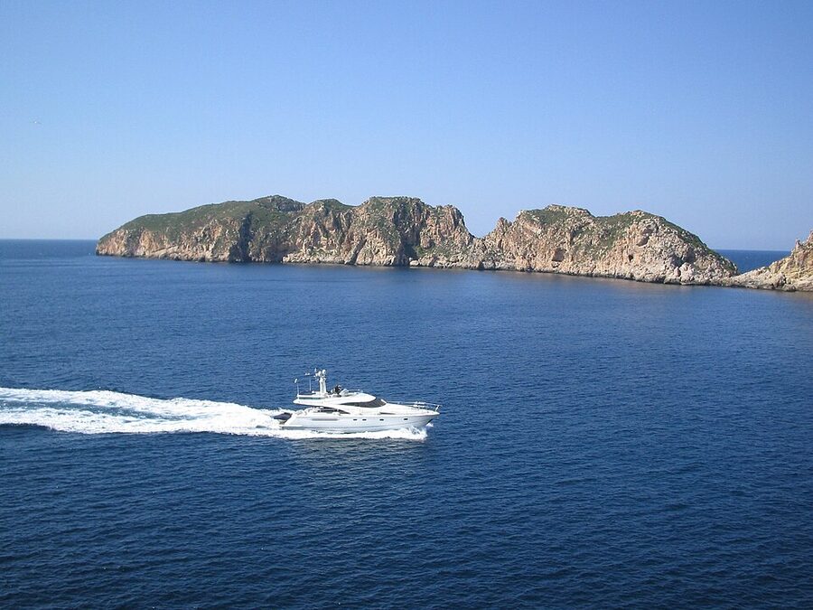 Yacht sailing past Malgrats Islands Mallorca
