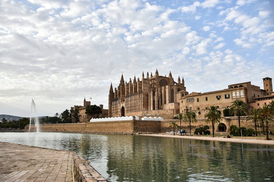 Palma Cathedral on the waterfront under cloudy skies