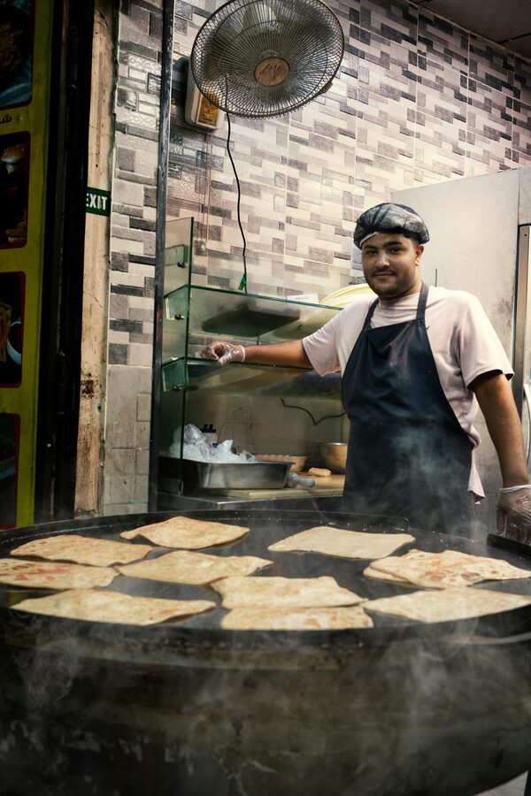 Street vendor cooking parathas on a hot griddle in Old Delhi