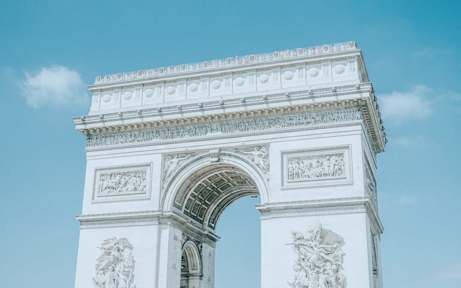 The Arc de Triomphe under a blue sky in Paris