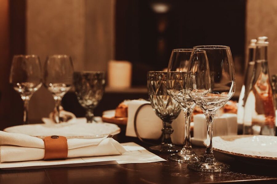 Sophisticated candlelit dinner table arrangement with glassware