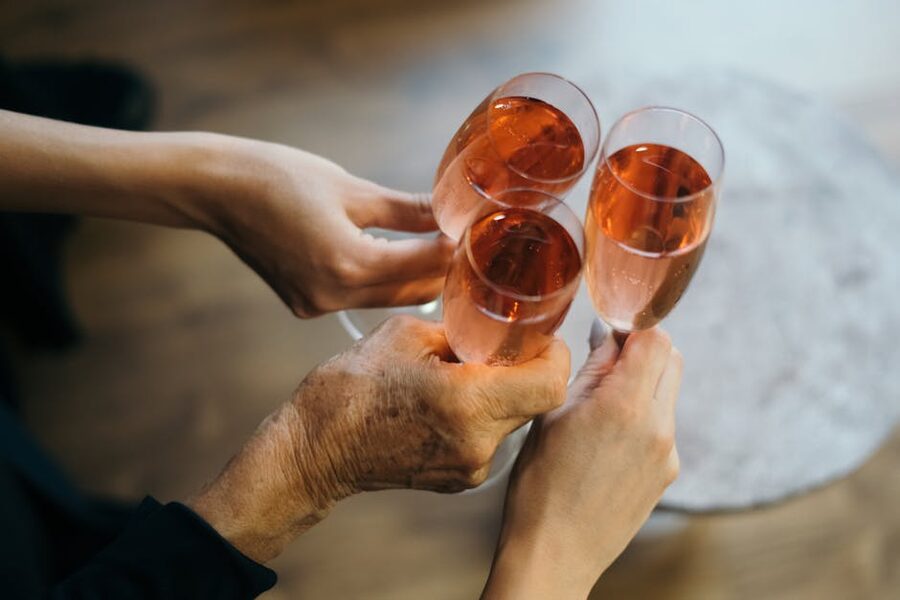 Hands clinking champagne glasses in a celebratory toast
