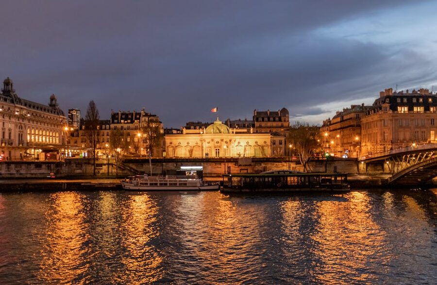 Illuminated Paris landmarks reflected in the Seine River at night