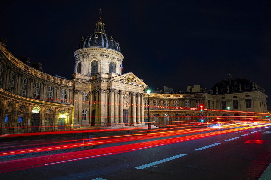 Illuminated Paris bridge over the Seine at night