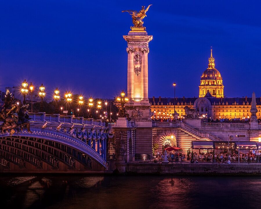 Pont Alexandre III and Hotel des Invalides illuminated at night