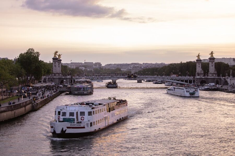 Pont Alexandre III bridge at sunset with Seine cruise boats below