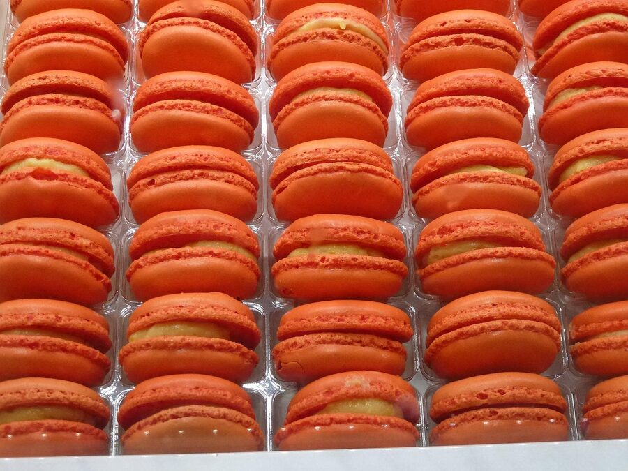 Paris orange macaron close-up at patisserie