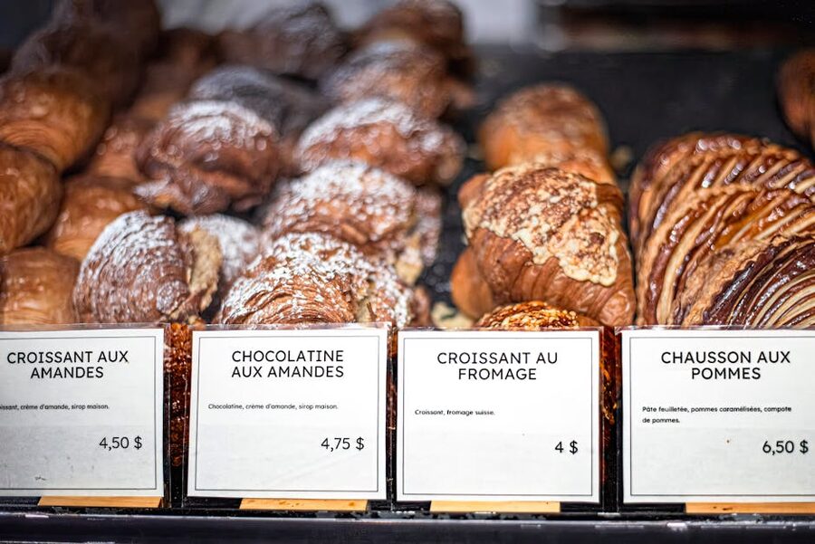 French pastries with handwritten price tags in a Paris bakery