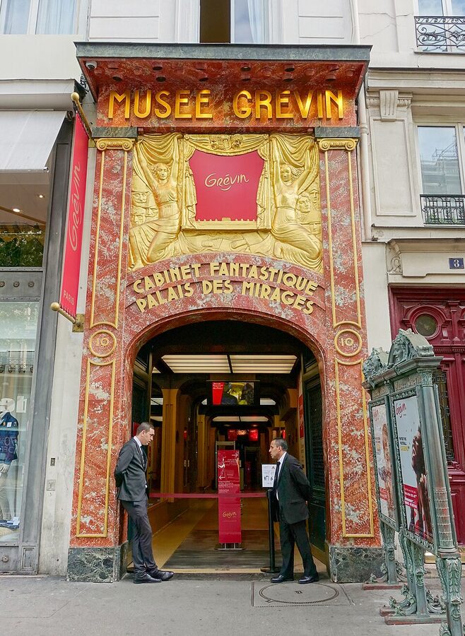 Two visitors at the Musee Grevin doorway on Boulevard Montmartre Paris