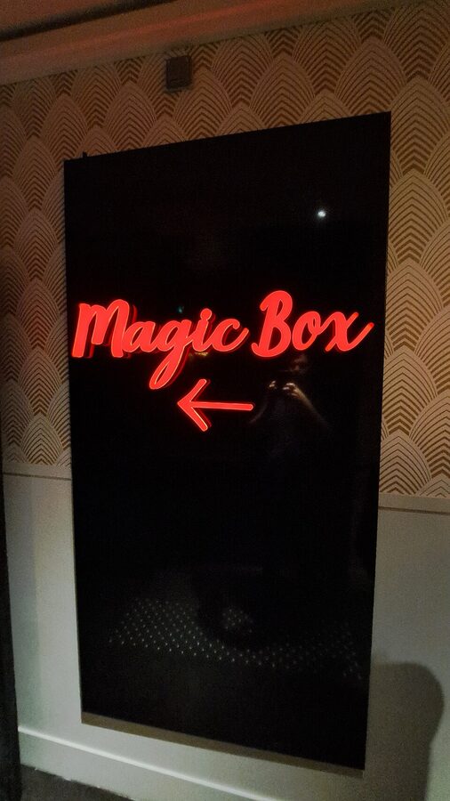 Magic Box illusion section red neon sign at Musee Grevin Paris