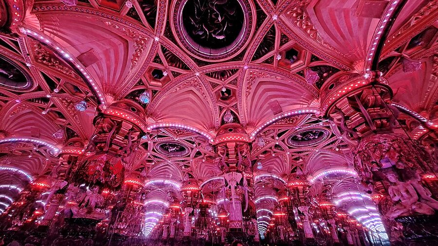 Palais des Mirages pink-lit panorama showing infinite reflected columns Paris