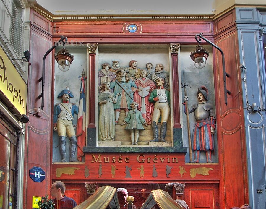 Side entrance of Musee Grevin in Passage Jouffroy with painted bas-relief Paris