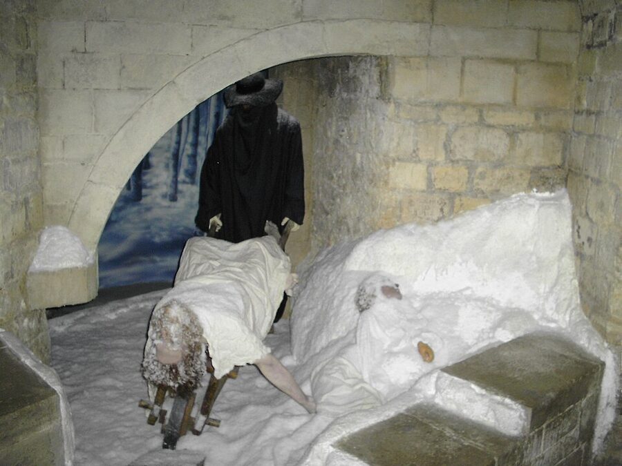 Plague scene tableau showing figure dragging body through snow at Musee Grevin