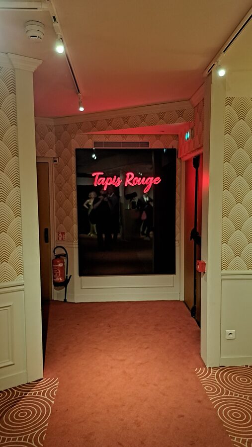 Tapis Rouge entry corridor with art deco wallpaper at Musee Grevin Paris