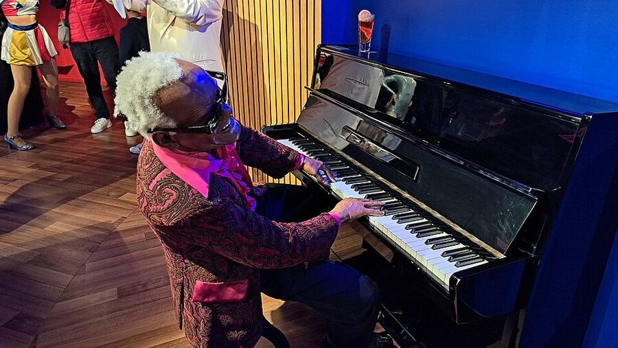 Wax figure of musician with curly white hair playing piano at Musee Grevin