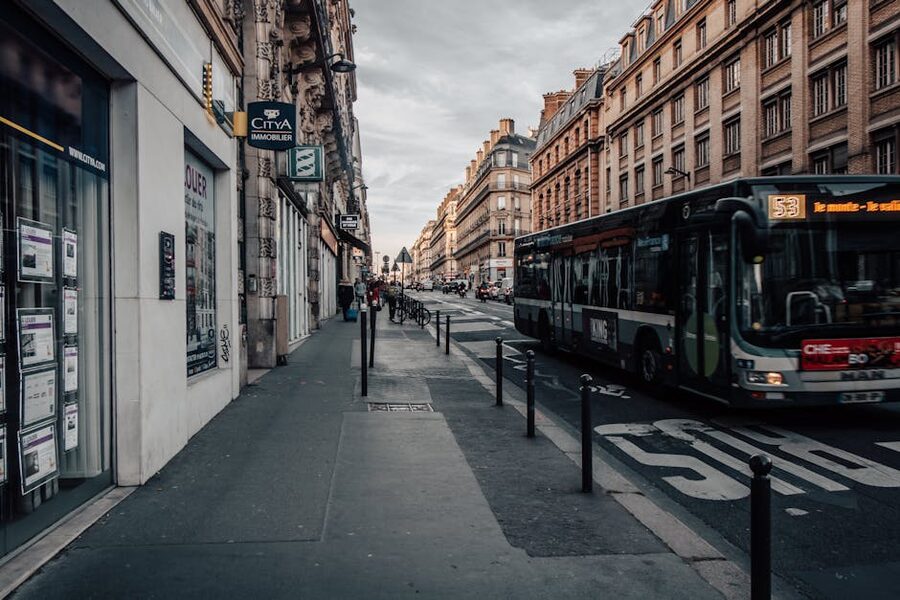 HOHO bus on a Parisian boulevard with historic Haussmann buildings