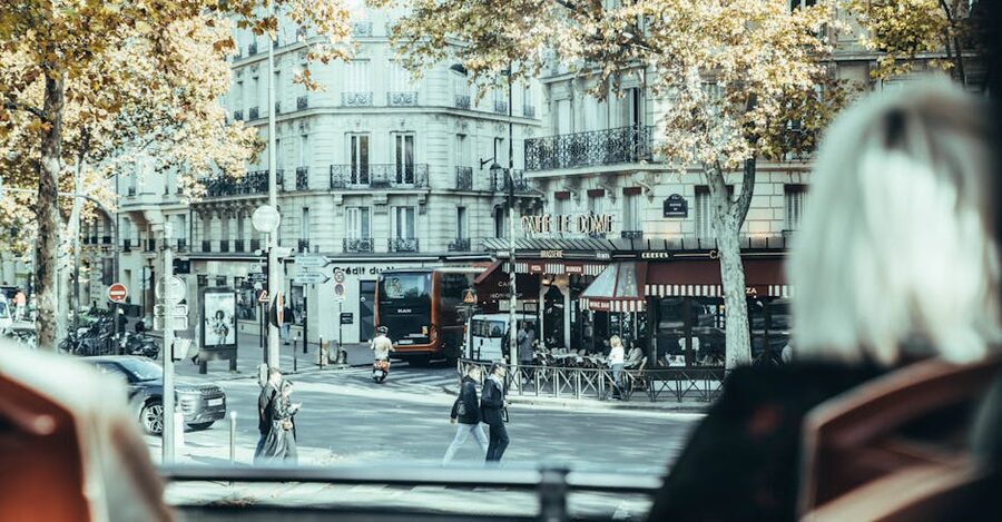 Cafe Le Dome Paris in autumn with HOHO bus traffic