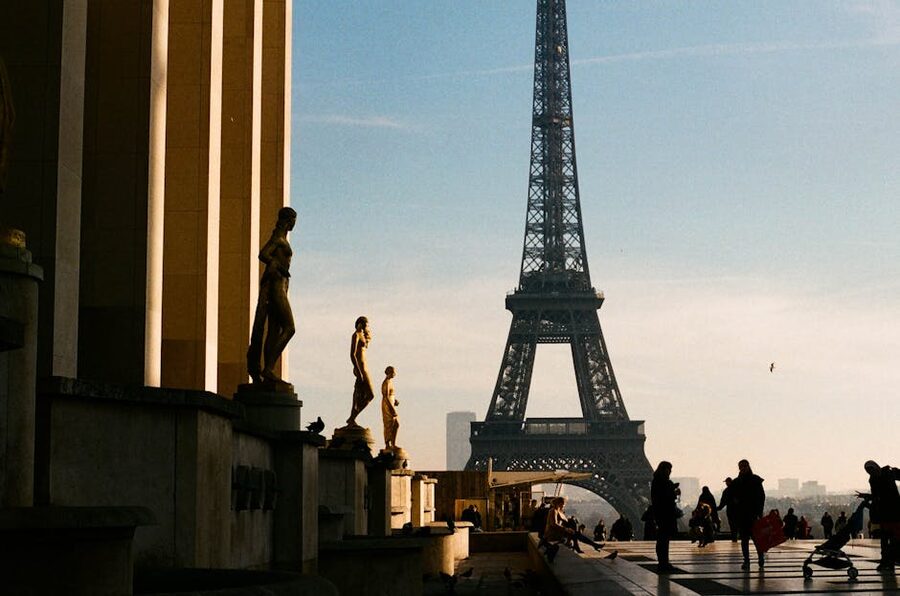 Eiffel Tower viewed from Trocadero with statues at golden hour