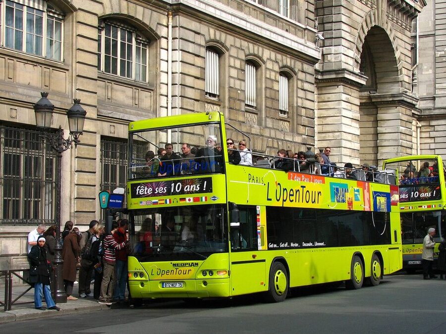 Yellow Open Tour Paris HOHO bus on a Paris boulevard