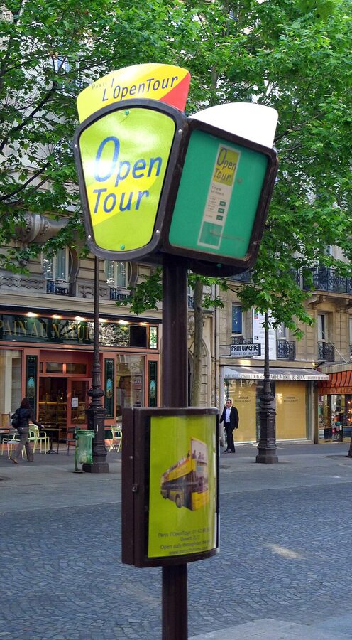 Hop-on hop-off bus stop sign pole on a Paris street