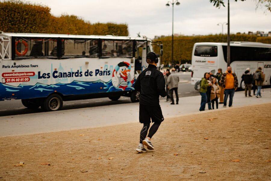 Tour buses on a Paris street with autumn foliage
