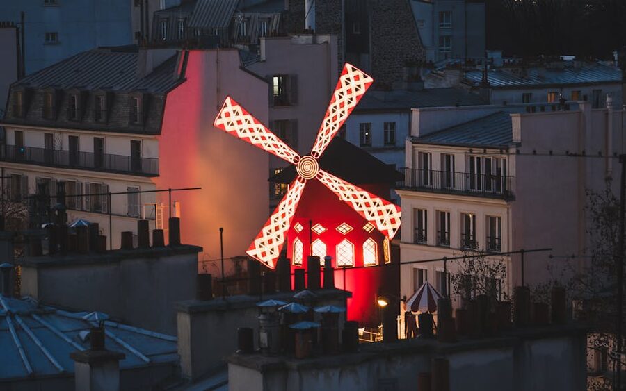 Moulin Rouge red windmill at evening twilight Paris