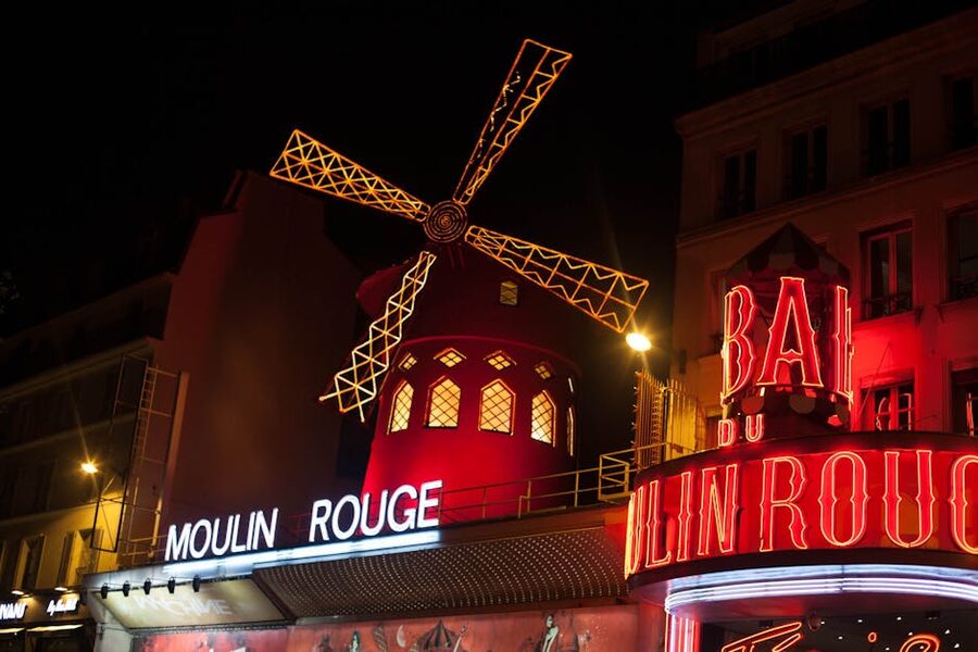 Moulin Rouge windmill illuminated at night Paris
