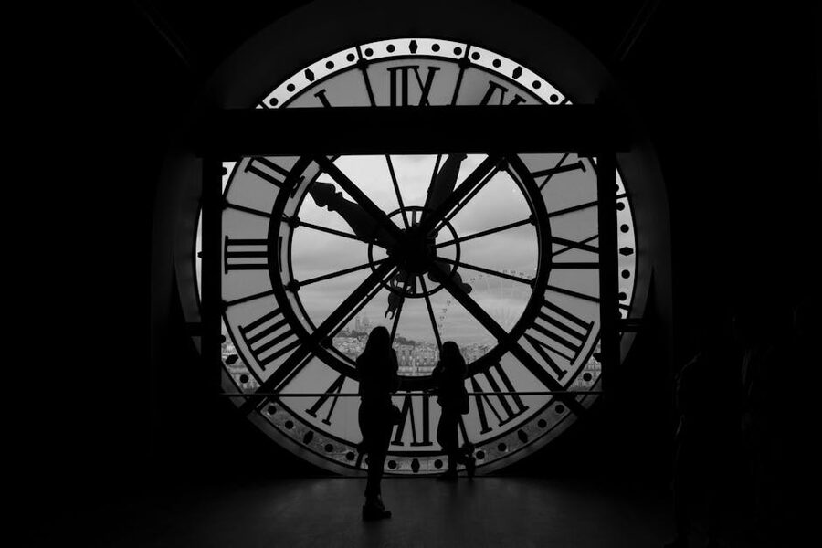 Visitors silhouetted against the giant clock at Musée d Orsay Paris