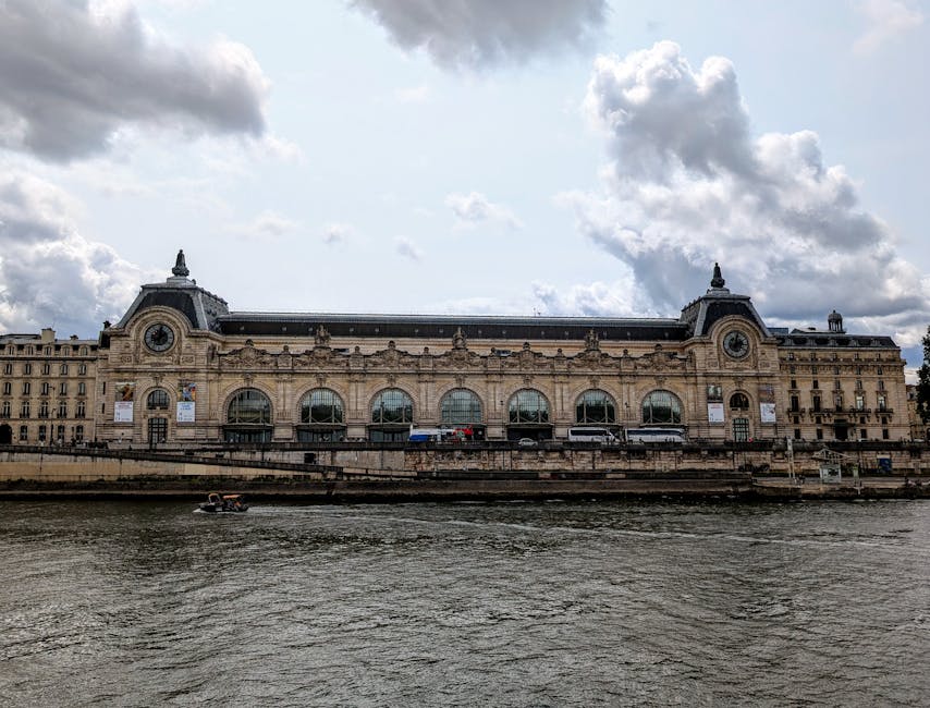 Musée d'Orsay exterior viewed along the Seine River in Paris