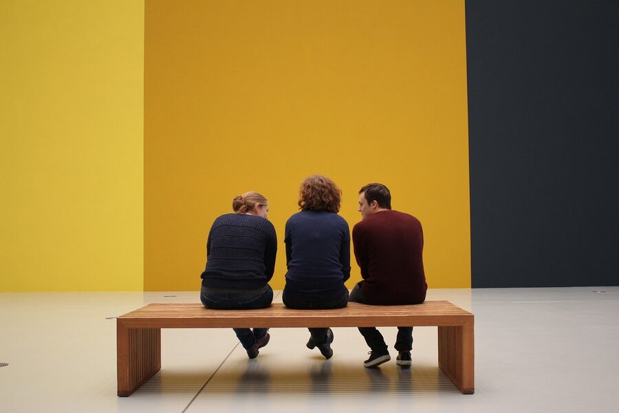 Visitors looking at artworks in a gallery