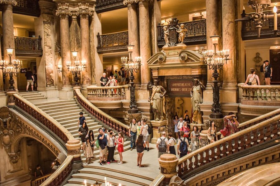 Visitors on the marble Grand Staircase inside Palais Garnier