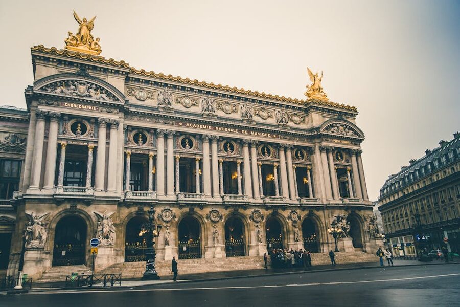 Low-angle view of Palais Garnier facade with sculptures