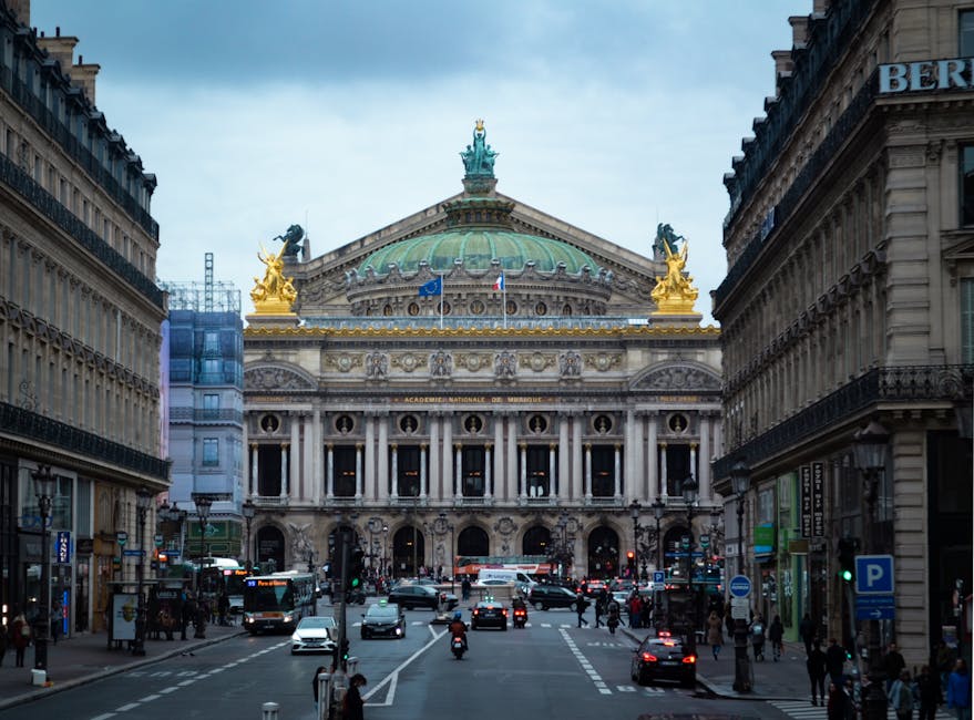 Place de l'Opera with traffic in front of Palais Garnier