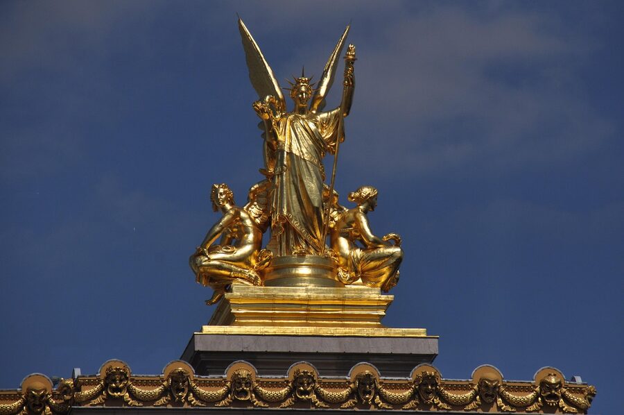 Gilded sculptures and academy of music inscriptions on the roof