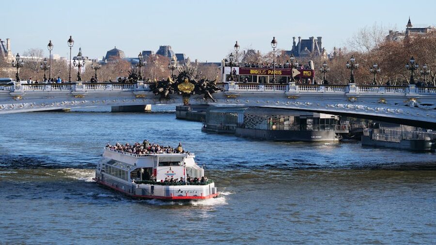 Seine cruise boat passing under the Pont Alexandre III bridge in Paris