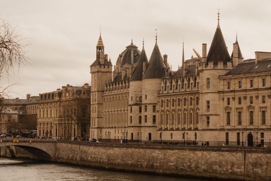 The Conciergerie on Ile de la Cite seen from the Seine river Paris