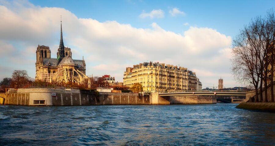 Notre Dame Cathedral beside the Seine River in Paris on a clear day