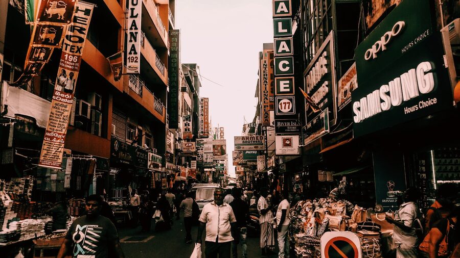 Busy street market in Colombo with vendors and pedestrians