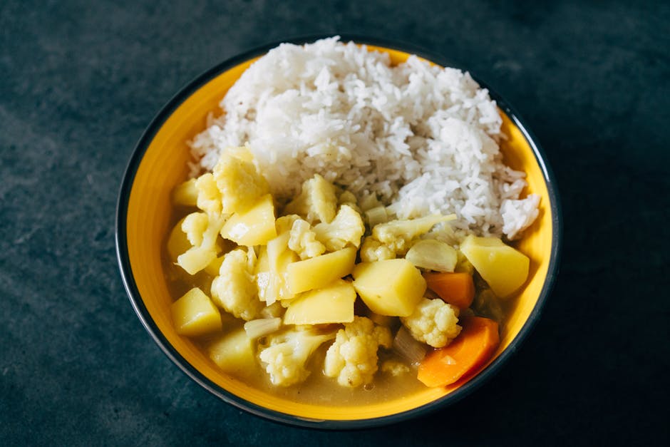 Vegetable curry with rice in a yellow bowl