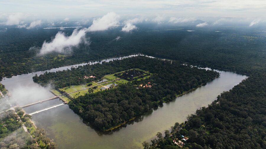 Breathtaking aerial view of Angkor Wat encircled by dense forest