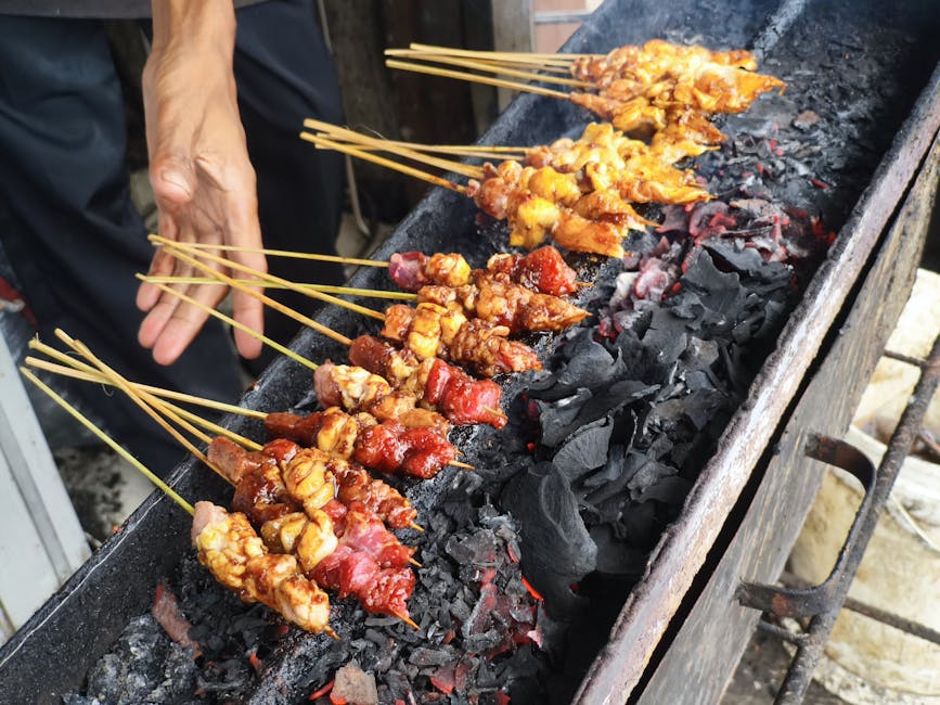 Vendor grilling Indonesian sate lilit skewers