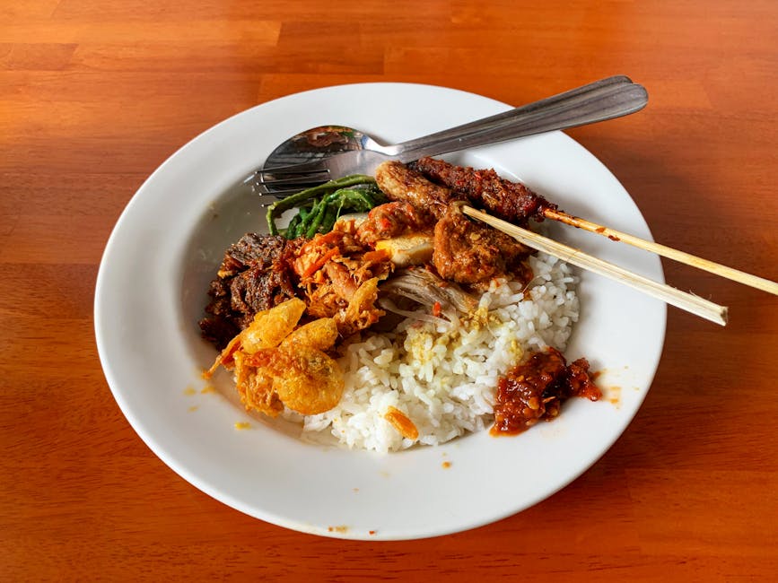 Nasi Campur plate with rice and side dishes in Bali