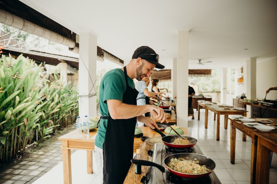 Chef preparing a meal in an open-air kitchen in Bali