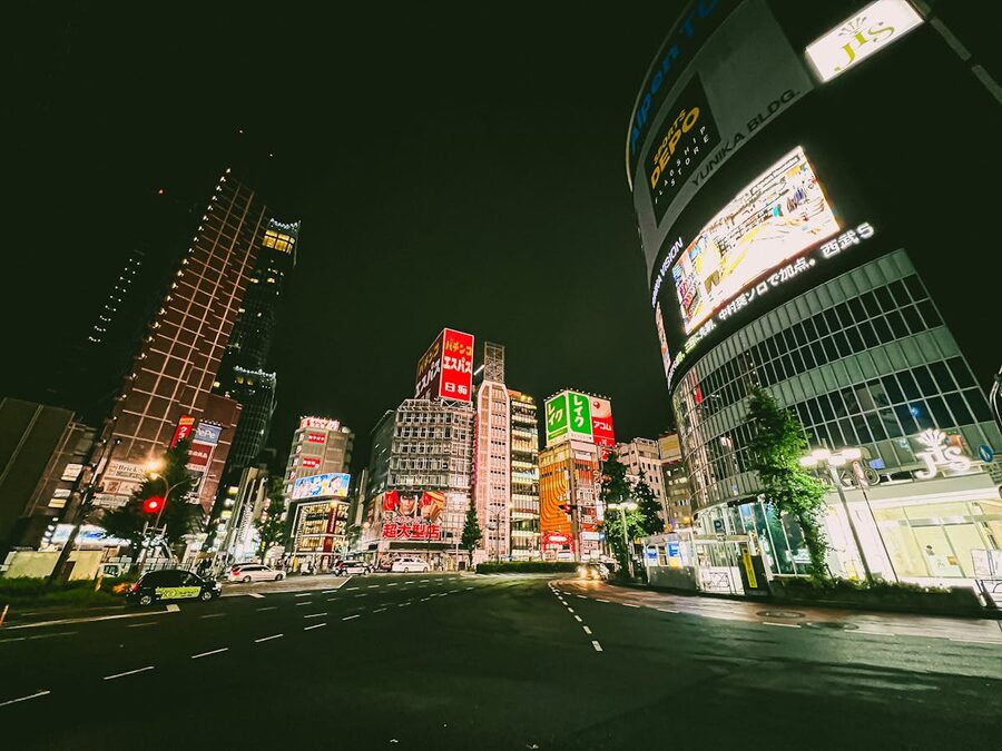 Shinjuku street at night with colorful neon signs and pedestrians