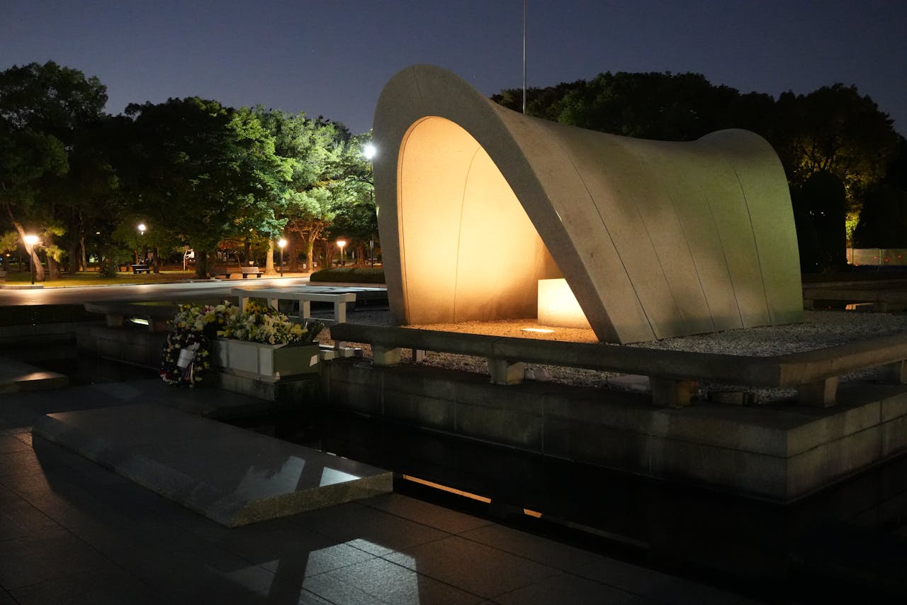 Illuminated Hiroshima Peace Memorial Park captured at night with serene reflections