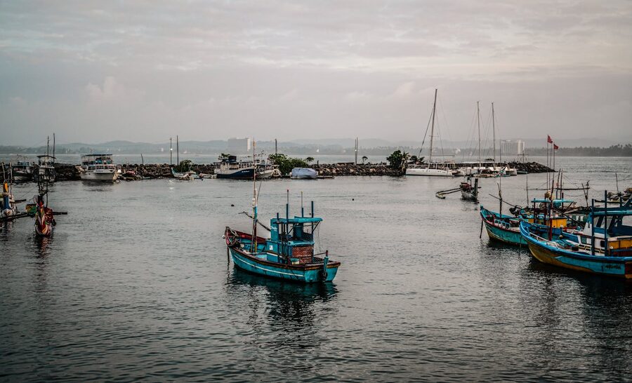 Fishing boats anchored in the serene Matara harbor Sri Lanka on a clear day
