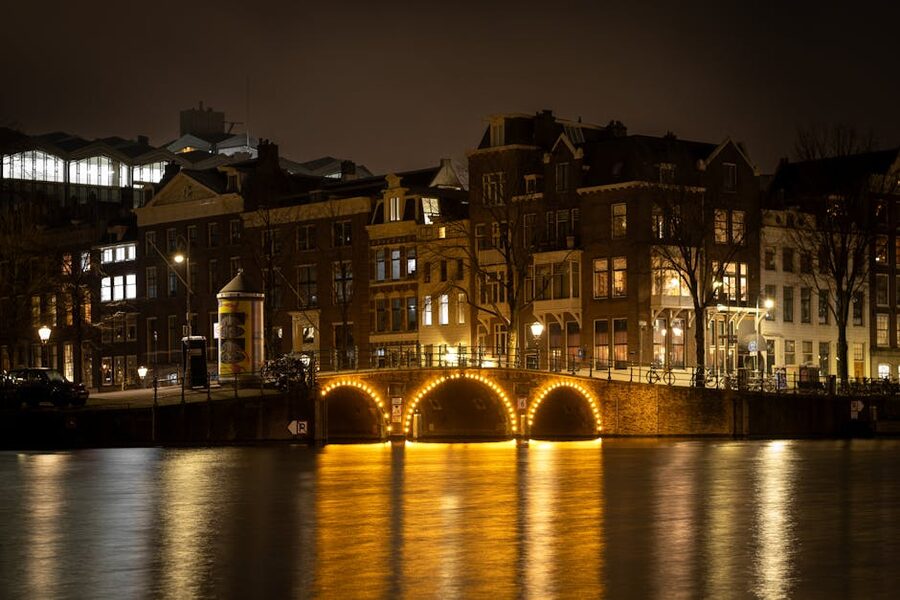 Illuminated canal bridge in Amsterdam at night