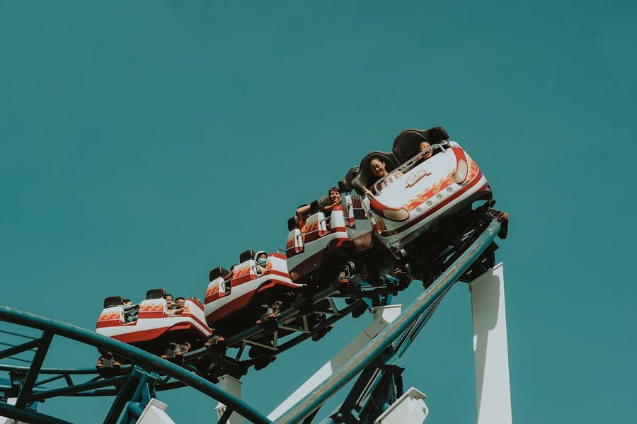 Group of people screaming and laughing on a roller coaster