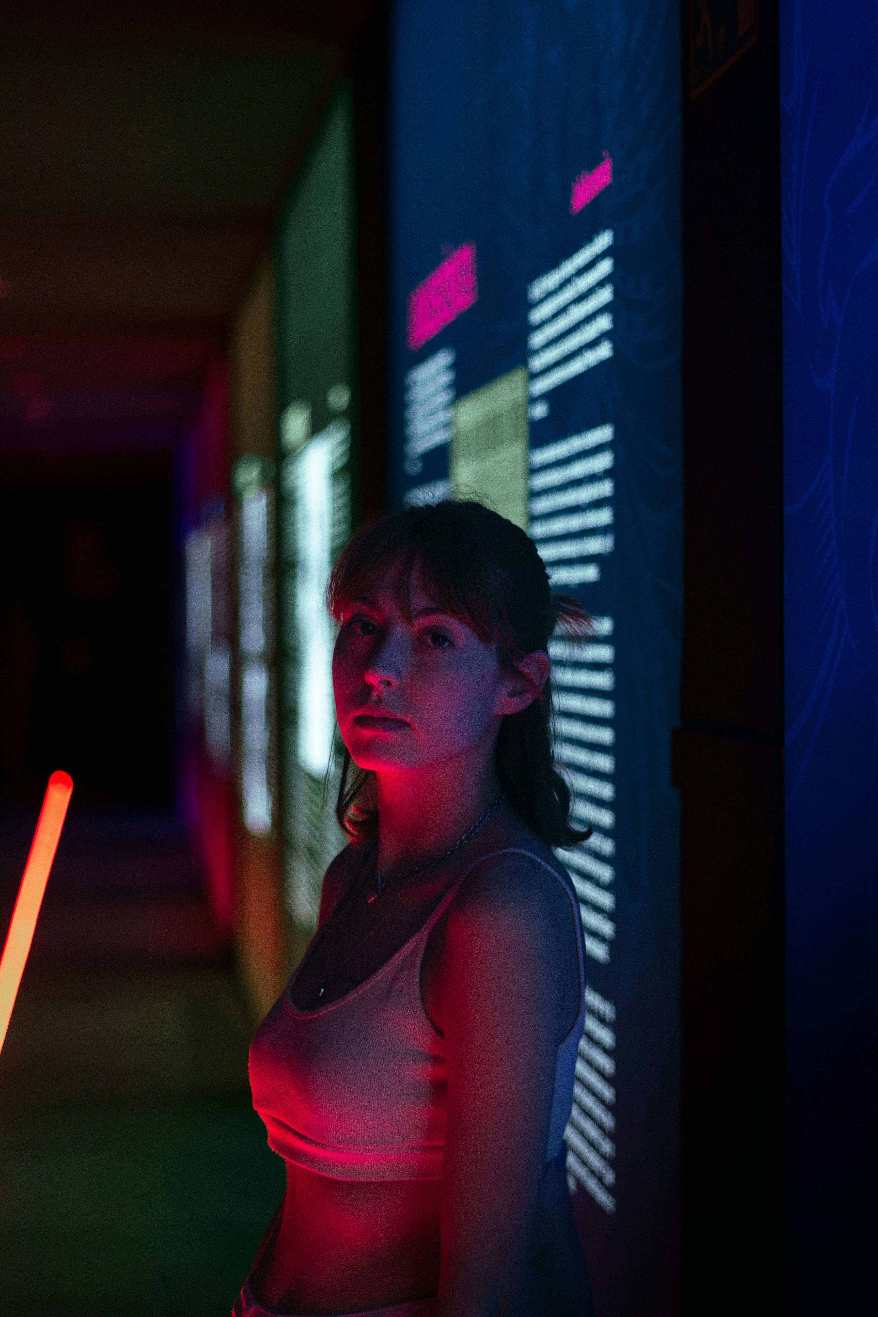 Woman illuminated by neon lights at digital art exhibition